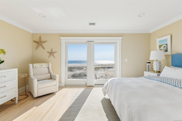 bedroom with light hardwood / wood-style flooring and ornamental molding