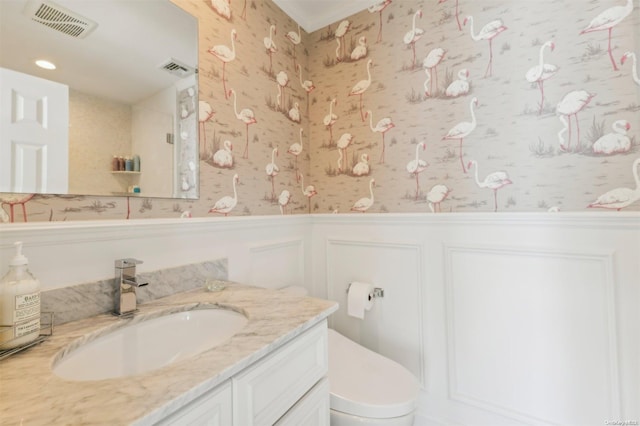 bathroom featuring vanity and toilet