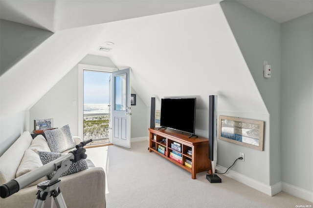 carpeted living room featuring lofted ceiling