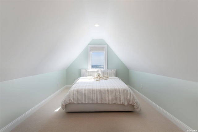 carpeted bedroom with vaulted ceiling