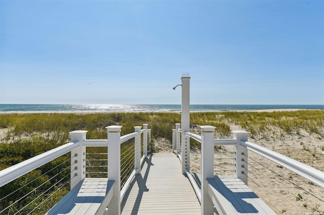 view of home's community featuring a beach view and a water view