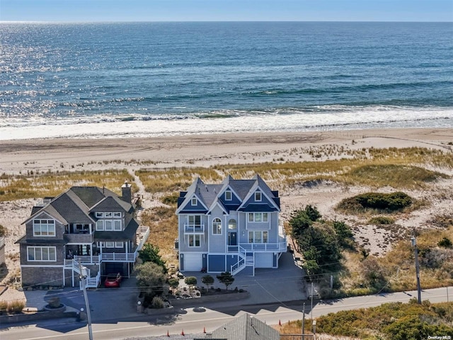 birds eye view of property with a water view and a view of the beach