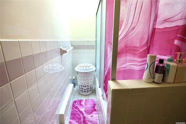 bathroom with tile walls