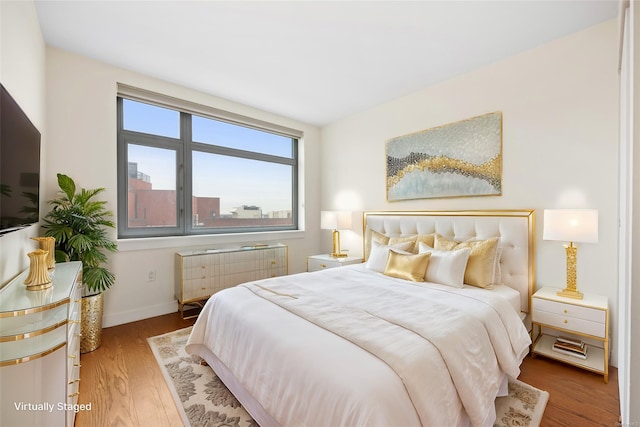 bedroom featuring radiator and hardwood / wood-style floors