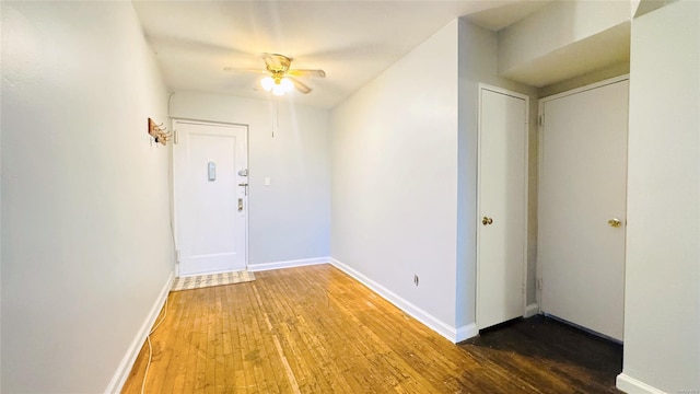 interior space with dark hardwood / wood-style flooring and ceiling fan