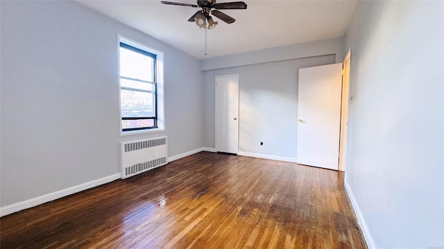 unfurnished bedroom featuring a closet, hardwood / wood-style flooring, radiator, and ceiling fan