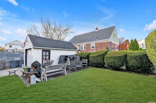 rear view of house with a yard, a patio, and an outdoor structure