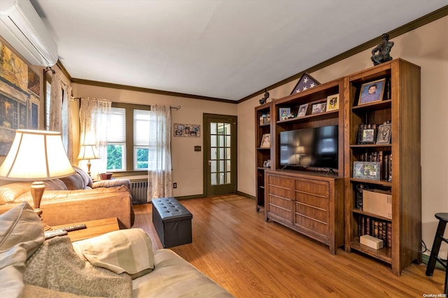 living room with wood-type flooring, a wall unit AC, radiator, and ornamental molding