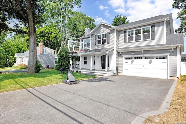 view of front of property with a front yard, a porch, and a garage