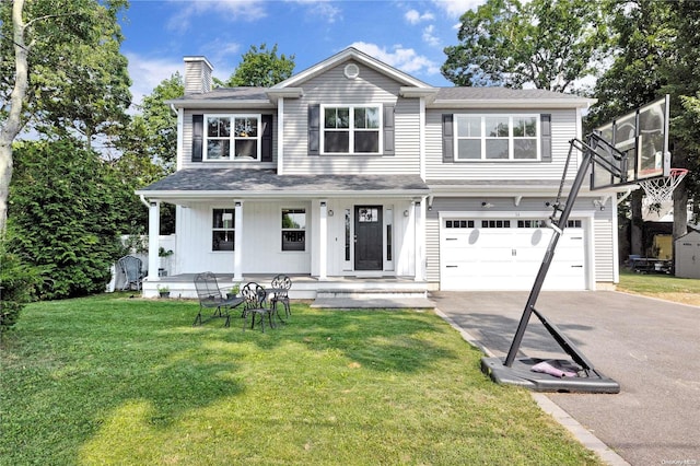 view of front of home featuring a porch, a garage, and a front yard