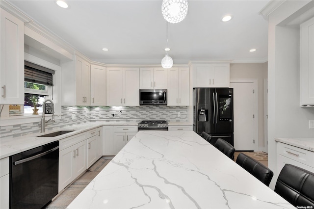 kitchen featuring appliances with stainless steel finishes, backsplash, a kitchen breakfast bar, sink, and hanging light fixtures