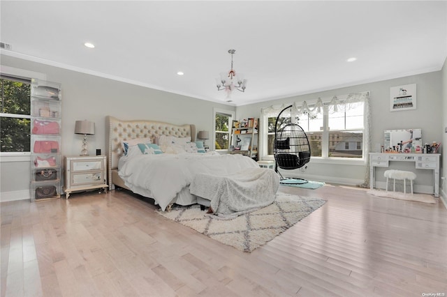 bedroom with an inviting chandelier, light hardwood / wood-style floors, and ornamental molding