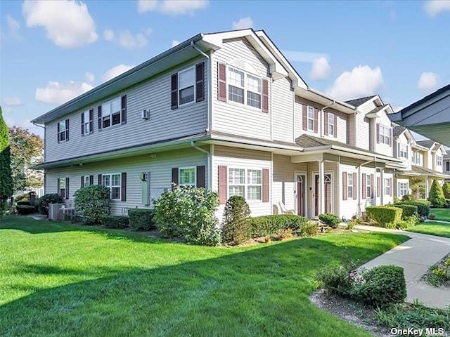 view of front of property featuring a front yard and central air condition unit