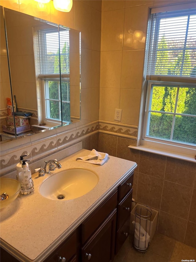 bathroom with tile patterned floors, vanity, and tile walls