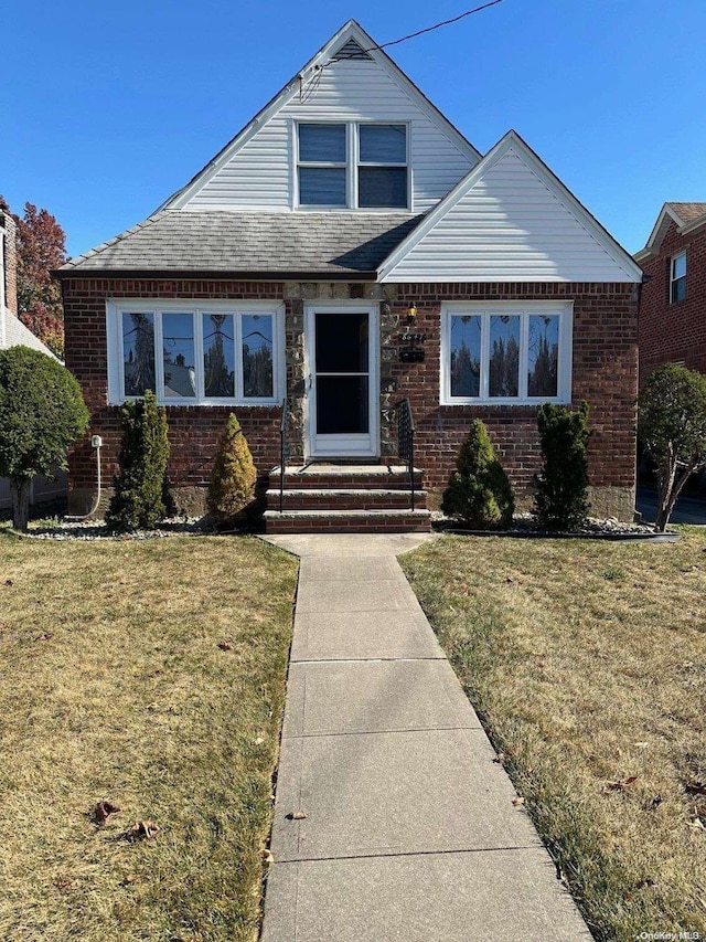 bungalow-style house with a front yard