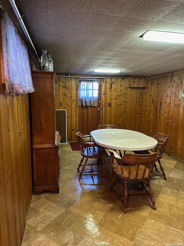 dining area featuring wooden walls