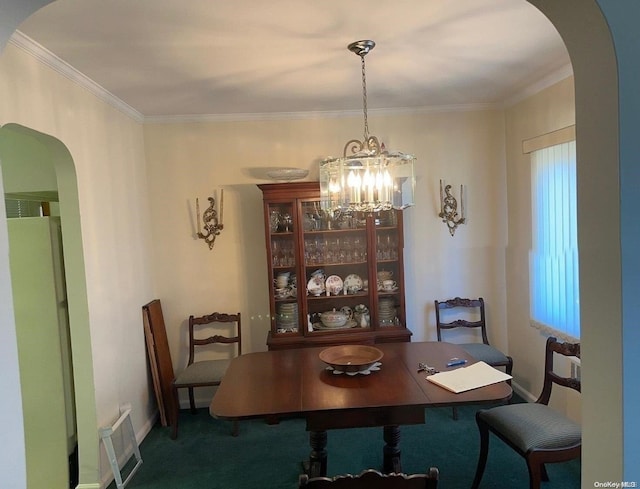 dining area featuring carpet flooring, ornamental molding, and an inviting chandelier