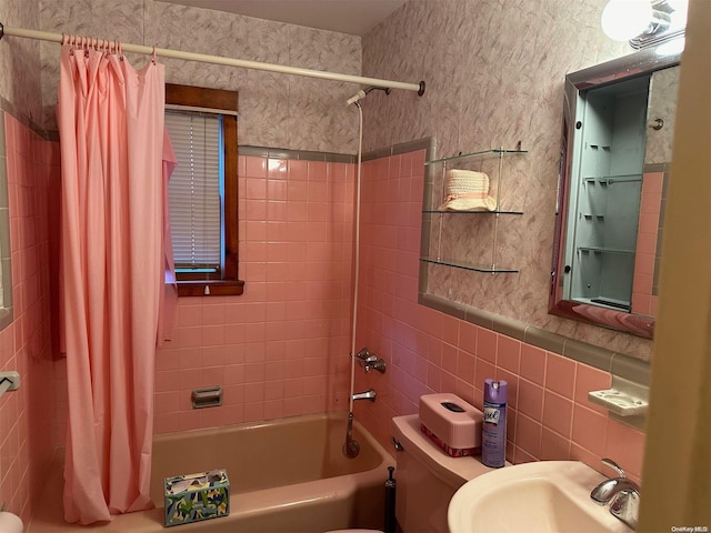 full bathroom with toilet, tile walls, shower / bath combo with shower curtain, and sink