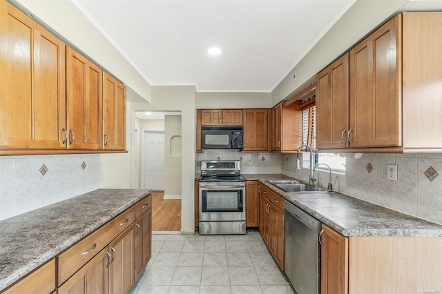 kitchen with decorative backsplash, stainless steel appliances, crown molding, sink, and light tile patterned floors