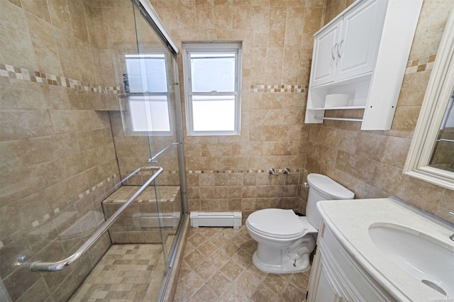 bathroom with vanity, a baseboard heating unit, toilet, tile walls, and an enclosed shower