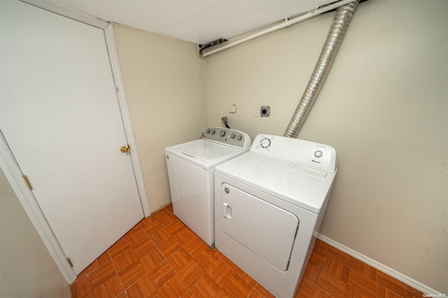 laundry room with light parquet floors and washing machine and clothes dryer