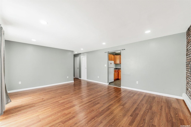 unfurnished room with light wood-type flooring