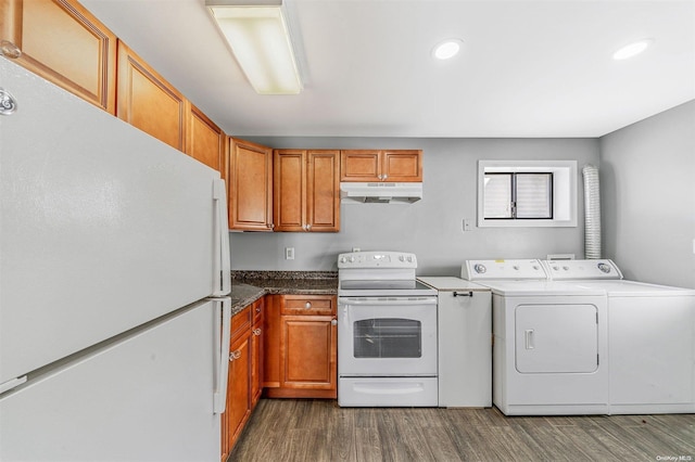 kitchen with white appliances, washing machine and dryer, and dark wood-type flooring