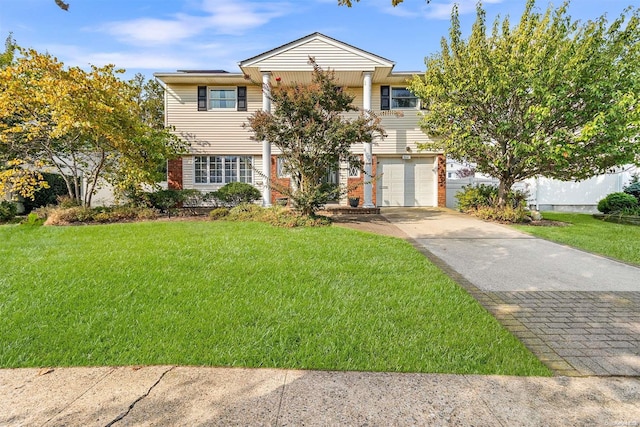 view of front of home featuring a front lawn and a garage