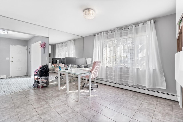 dining room featuring baseboard heating and light tile patterned floors