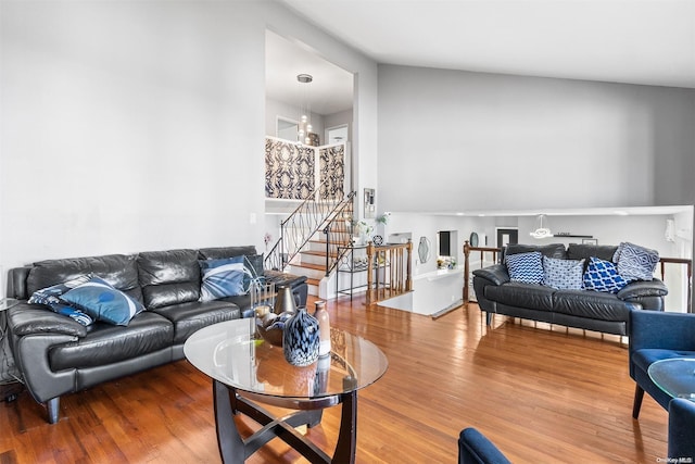 living room with hardwood / wood-style floors and vaulted ceiling