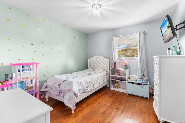 bedroom with hardwood / wood-style flooring