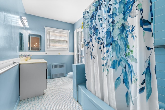 full bathroom featuring vanity, shower / bath combo, tile patterned flooring, toilet, and radiator heating unit