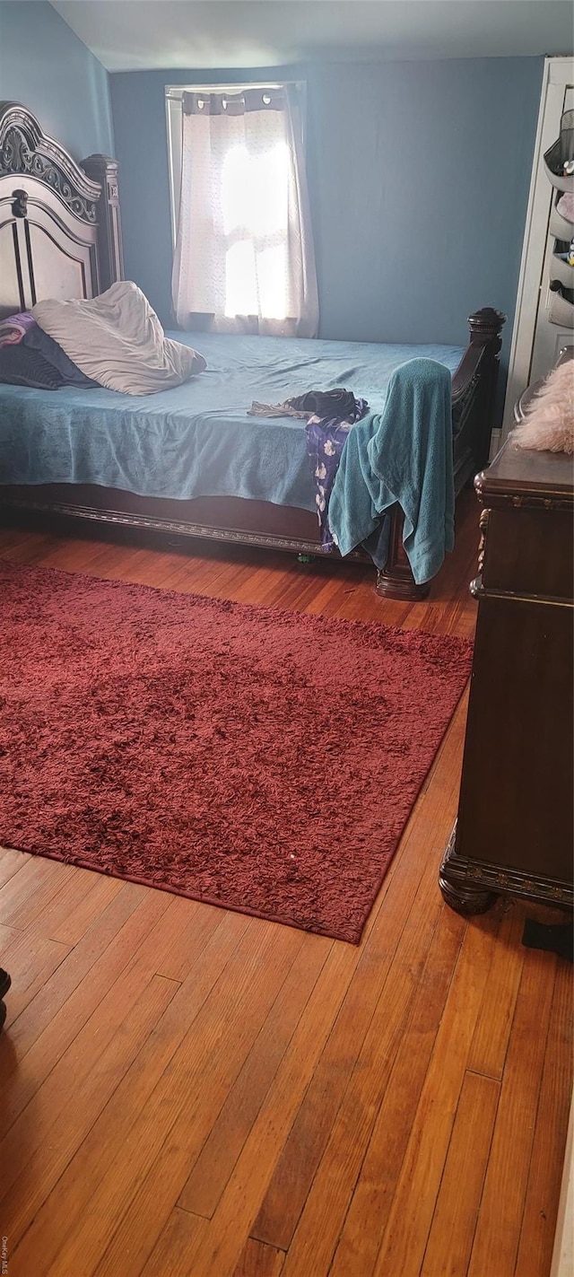 bedroom with hardwood / wood-style flooring