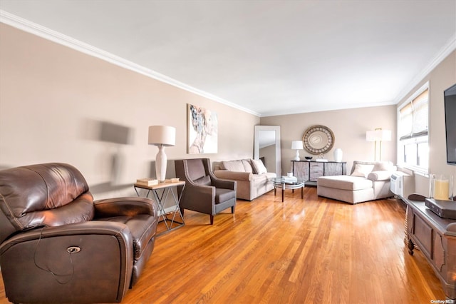 living room featuring light hardwood / wood-style floors and ornamental molding