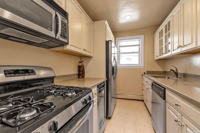 kitchen featuring appliances with stainless steel finishes, baseboard heating, and sink