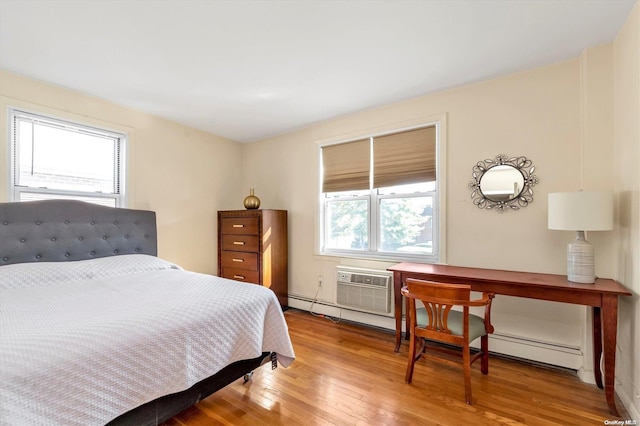 bedroom featuring light hardwood / wood-style floors and an AC wall unit