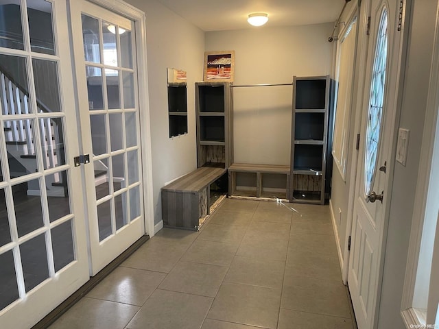 mudroom featuring tile patterned floors, plenty of natural light, and french doors