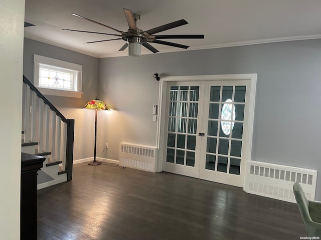 empty room featuring french doors, crown molding, radiator heating unit, and dark hardwood / wood-style floors