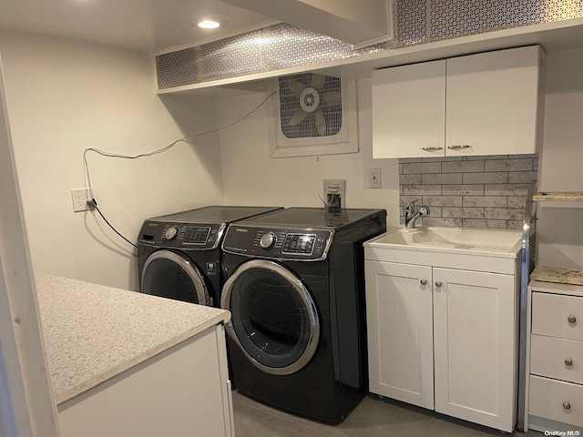 laundry area with cabinets, sink, and washing machine and clothes dryer