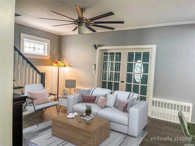 living room with hardwood / wood-style flooring, ceiling fan, ornamental molding, and radiator