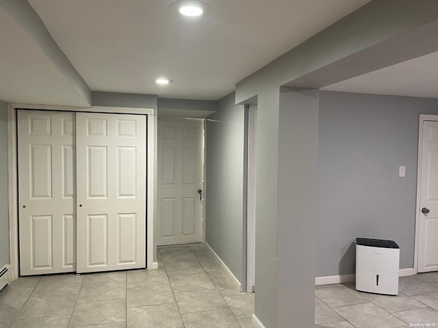 corridor with light tile patterned flooring