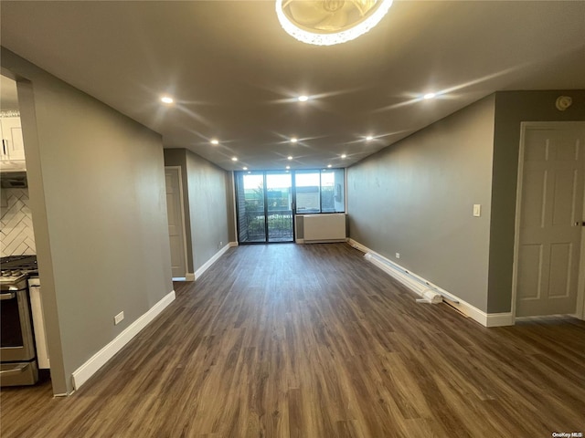 unfurnished room featuring floor to ceiling windows and dark wood-type flooring