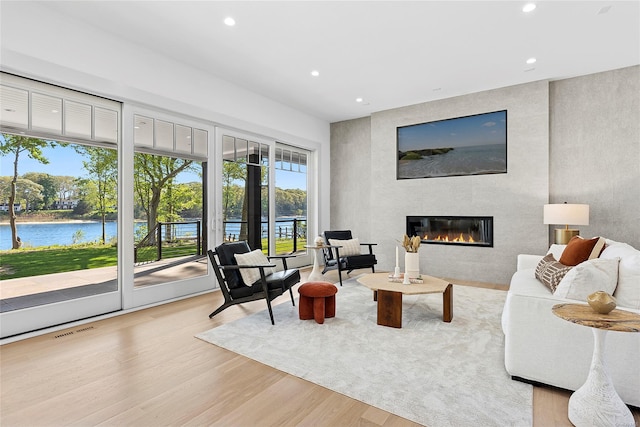 1750 Hobart Rd, Southold, NY 11971 - living room featuring a fireplace, recessed lighting, wood finished floors, and a water view