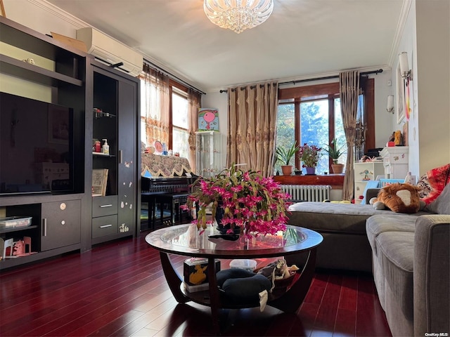 living room with radiator, ornamental molding, plenty of natural light, and a wall mounted air conditioner