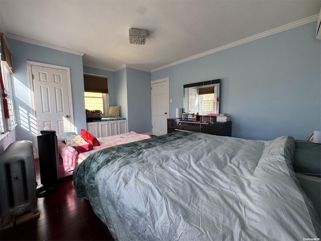 bedroom with ornamental molding, multiple windows, dark hardwood / wood-style floors, and radiator