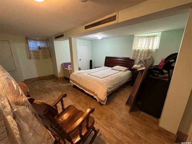 bedroom with wood-type flooring