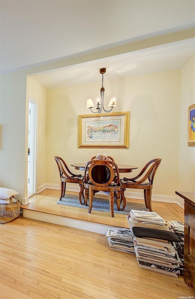 dining room featuring wood-type flooring and a chandelier