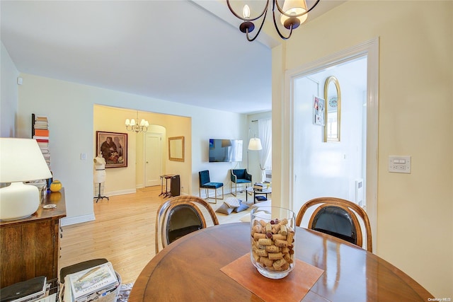 dining area featuring a chandelier and light hardwood / wood-style flooring