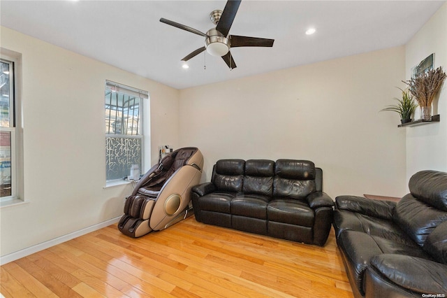 living room with wood-type flooring and ceiling fan