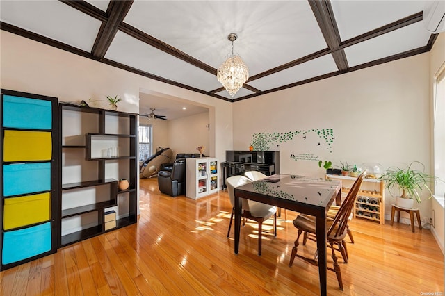 dining area featuring hardwood / wood-style floors, coffered ceiling, ceiling fan with notable chandelier, ornamental molding, and a wall unit AC